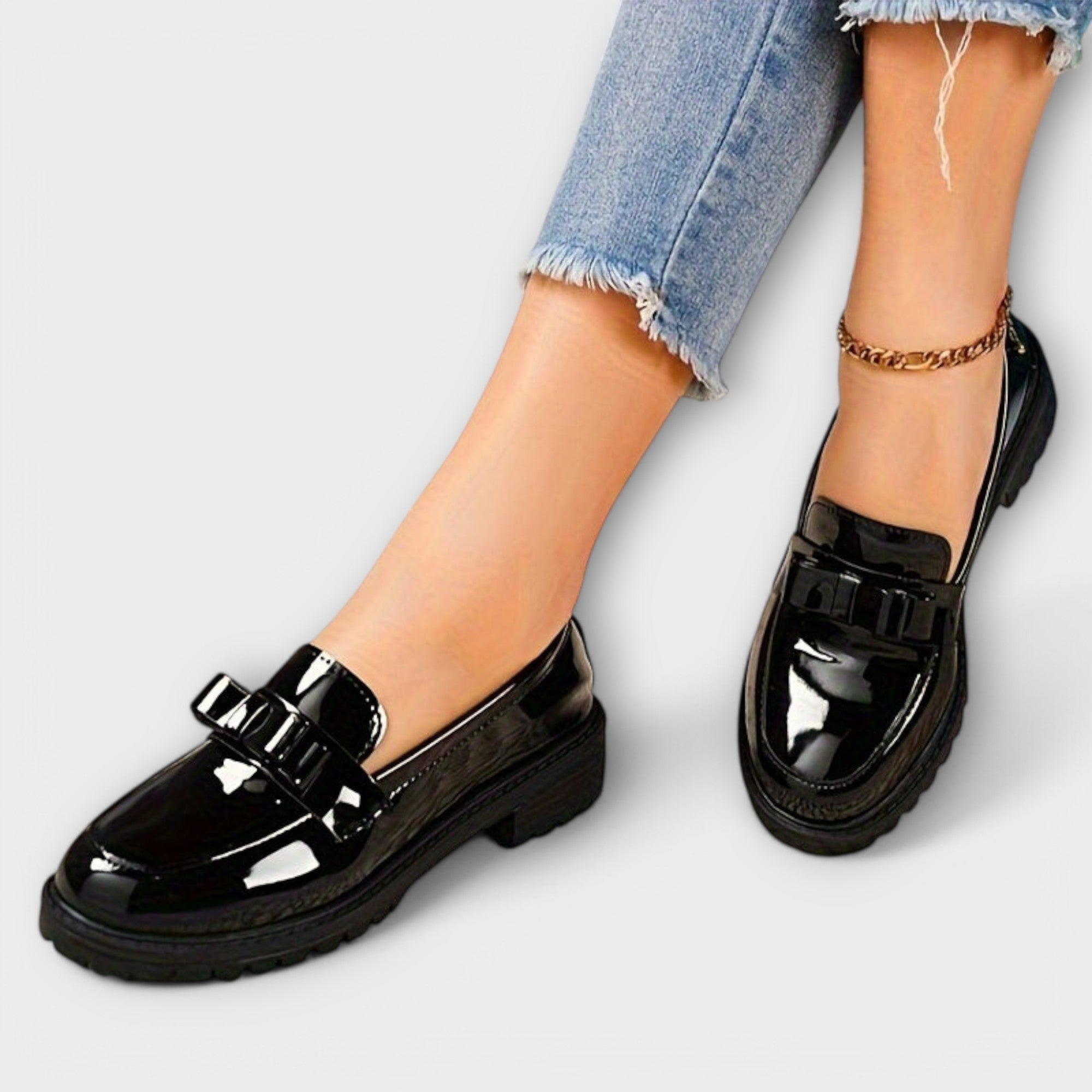 Women's patent leather loafers with a bow