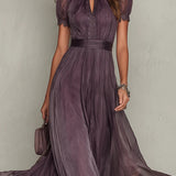 Flávia's long purple dress with a plunging neckline