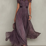 Flávia's long purple dress with a plunging neckline