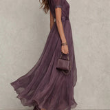 Flávia's long purple dress with a plunging neckline