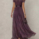 Flávia's long purple dress with a plunging neckline